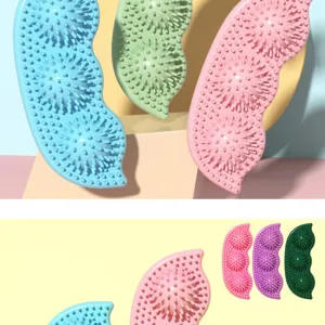 Detailed macro view of colorful pea-shaped dog chew toys with dental nubs