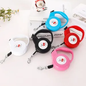 Selection of five colorful automatic retractable cat leashes displayed on a white table
