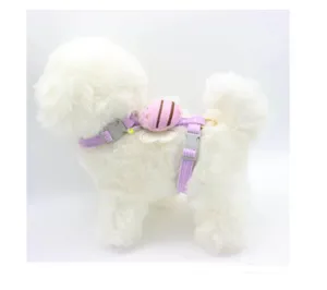 Detail of purple corduroy pet harness with cute pink bee pouch on white plush dog
