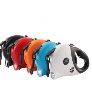 Multiple colors of retractable pet leashes featuring integrated LED flashlights.