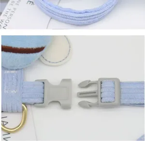 Detailed macro shot of the durable plastic buckle and soft blue corduroy pet harness