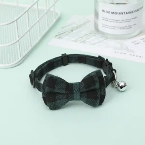 Detail view of green plaid adjustable pet collar with a large bowtie and silver bell.
