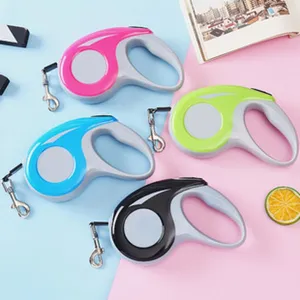 Retractable pet leashes in pink blue green and black colors on colorful background.