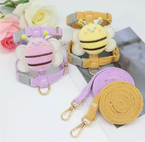 Close-up of cute bee-shaped corduroy pet harness and matching leash set in yellow and purple.