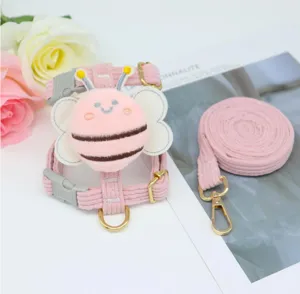 Detailed view of pink corduroy pet harness and leash set with a plush bee design