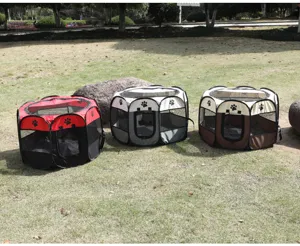 Three portable octagonal pet playpens in red, grey, and brown displayed on a grass lawn.