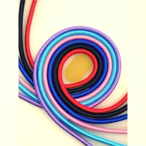 Detailed macro view of colorful braided climbing-style round pet dog leashes coiled together.
