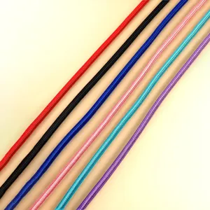 Close-up of colorful braided round pet leashes in red, black, blue, and purple