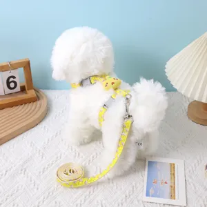 Detail view of an adjustable yellow floral dog harness and leash set on a white pet