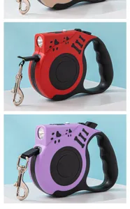 Close-up view of red and purple retractable dog leashes with LED lights and metal clips.