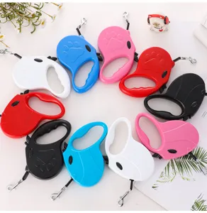 Overhead view showing various colorful automatic retractable dog leashes arranged in a circle