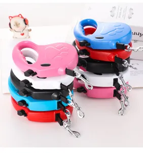 Detail view of retractable dog leashes in multiple colors with cute paw print design