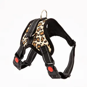 Side view detail of leopard print dog harness with reflective straps and red buckles