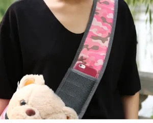 Close-up detail of pink camouflage pet carrier shoulder strap with integrated mesh pocket