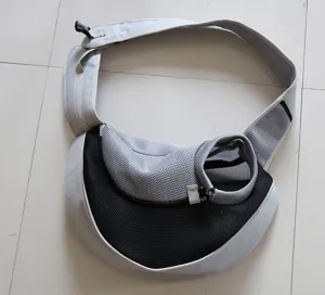 Close-up detail of the breathable mesh material and adjustable strap on gray pet carrier bag