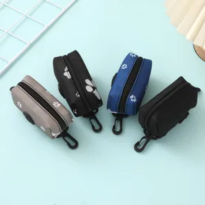 Portable pet waste bag dispensers in various colors featuring cute paw print patterns