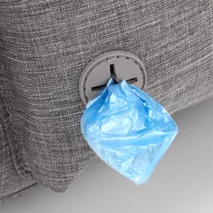 Detailed macro view of the waste bag dispenser feature on a grey fabric pet carrier bag