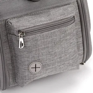 Close-up of grey fabric pet carrier pocket with durable zipper and waste bag dispenser