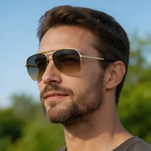 Dettaglio occhiali da sole aviator da uomo in metallo dorato con lenti sfumate marroni