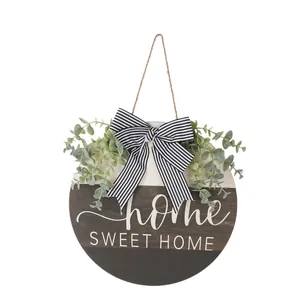 Wooden door hanger with eucalyptus greenery, striped bow, and Home Sweet Home text