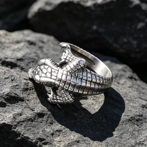 Detailed vintage crocodile stainless steel animal ring displayed on dark rocks