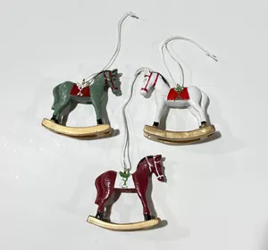 Three colorful painted resin rocking horse ornaments with white hanging strings for Christmas decor