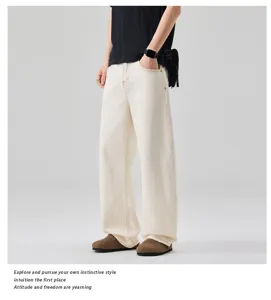 Detail shot of men's off-white loose wide leg jeans, casual denim pants view close up.
