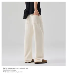 Detail view of casual men's off-white wide leg denim jeans, showing back pocket and fit.