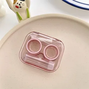 Macro view of a portable transparent pink contact lens case set with L and R cups