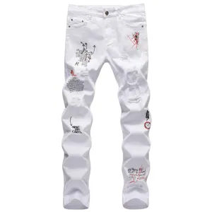 Men's white distressed streetwear jeans detail view with unique graffiti prints and ripped design.