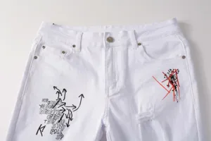 White men's slim straight denim jeans with street style embroidery and distressed rips details.