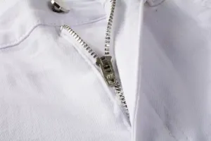 Detailed close-up of white mens denim jeans zipper fly hardware texture and stitching.