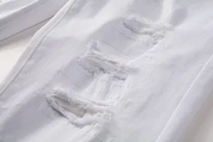 Detail view of men's white ripped stretch slim straight jeans with distressed embroidery patches.