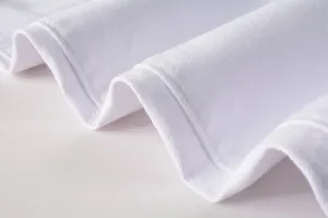 Close-up detail of premium white denim fabric showing fine twill texture and neat stitching.