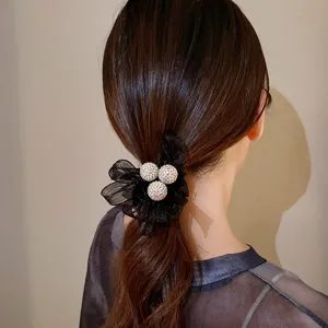 Élégant chouchou en tulle noir avec billes de strass scintillantes pour queues de cheval.