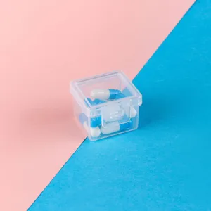 Close-up detail of mini square transparent plastic storage box with secure flip-top lid