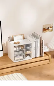 Detailed view of white minimalist desk organizer with integrated bookends and drawers