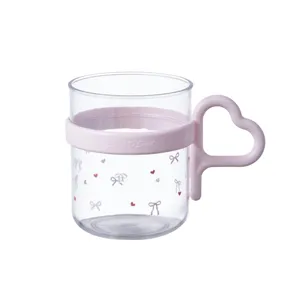 Cute clear plastic mouthwash cup with pink heart-shaped handle and sweet bow pattern