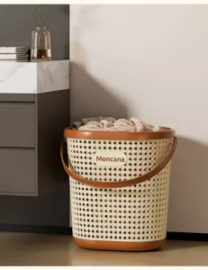 Close-up view of the cream and brown rattan-style laundry hamper with woven design