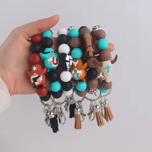 Detailed shot of western cowboy silicone beaded wristlet keychains with cute charms and tassels.