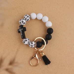 Silicone beaded wristlet keychain with cross print, black tassel and metal clasp for women.