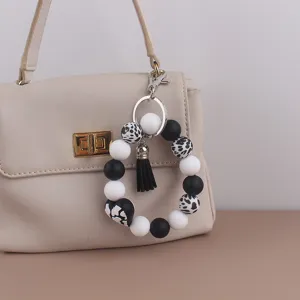 Western cow print silicone beaded keychain bracelet with black tassel accessory for women bags.