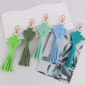 Handmade woven heart tassel keychain detail, bohemian style bag charm with gold lobster clasp.