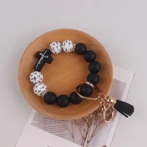 Silikon Perlen Schlüsselanhänger Armband mit Kreuz Anhänger und Quaste, modisches Accessoire.