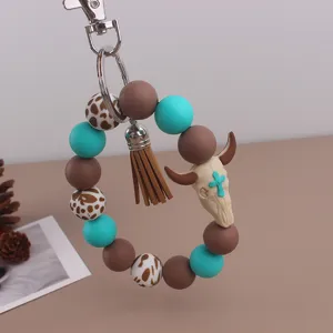 Western cowboy style silicone beaded keychain with tassel and bull skull pendant for bags and keys.
