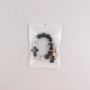 Schwarze weiße Silikonperlen Kreuz Schlüsselanhänger Armband mit Quaste modisches Accessoire.