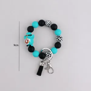 Silicone bead keychain bracelet with tassel and gnome charm, stylish bag accessory for women.