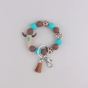 Western silicone bead wristlet keychain with bull skull pendant and leather tassel charm.