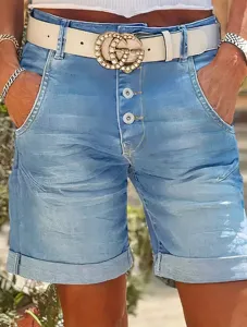 Detail view of high-waist stretch denim shorts with button fly and rolled cuffs