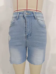 Detailed front view of women's light wash distressed high-waisted denim shorts on mannequin